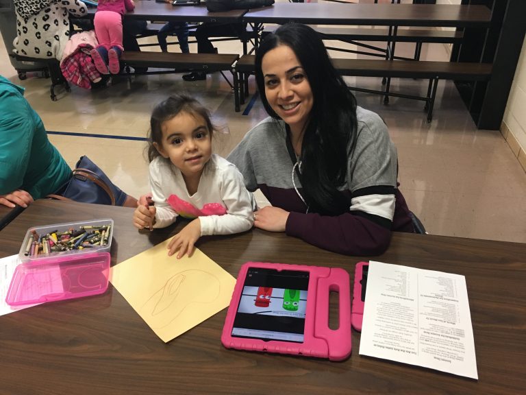 A parent helps her preschooler