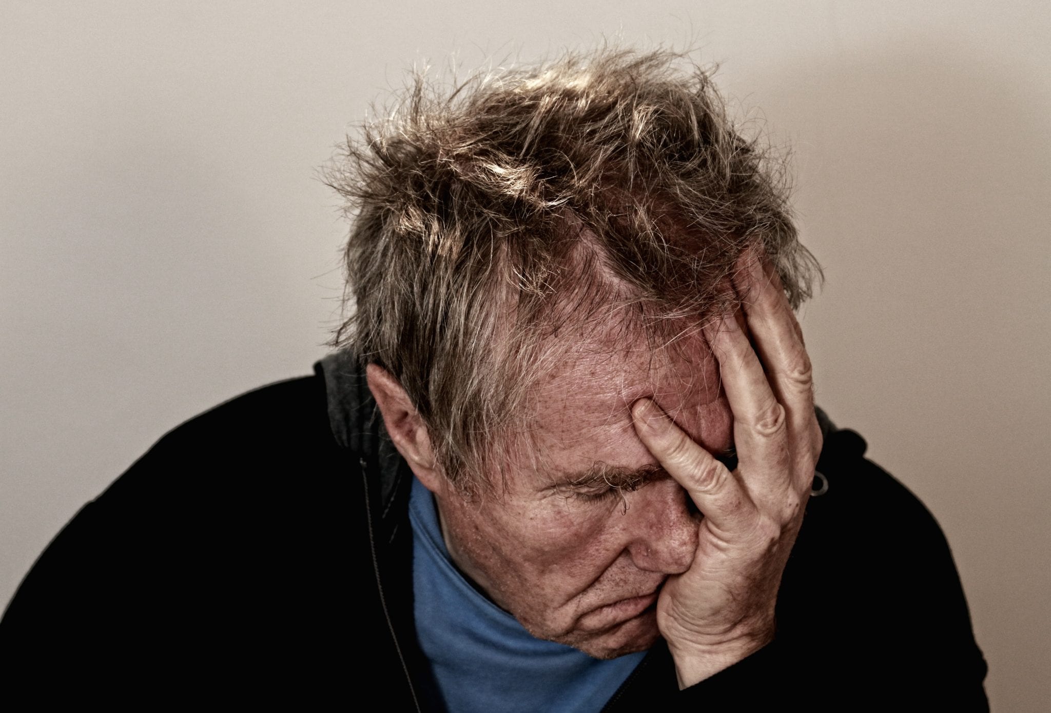 man holding his head in disappointment