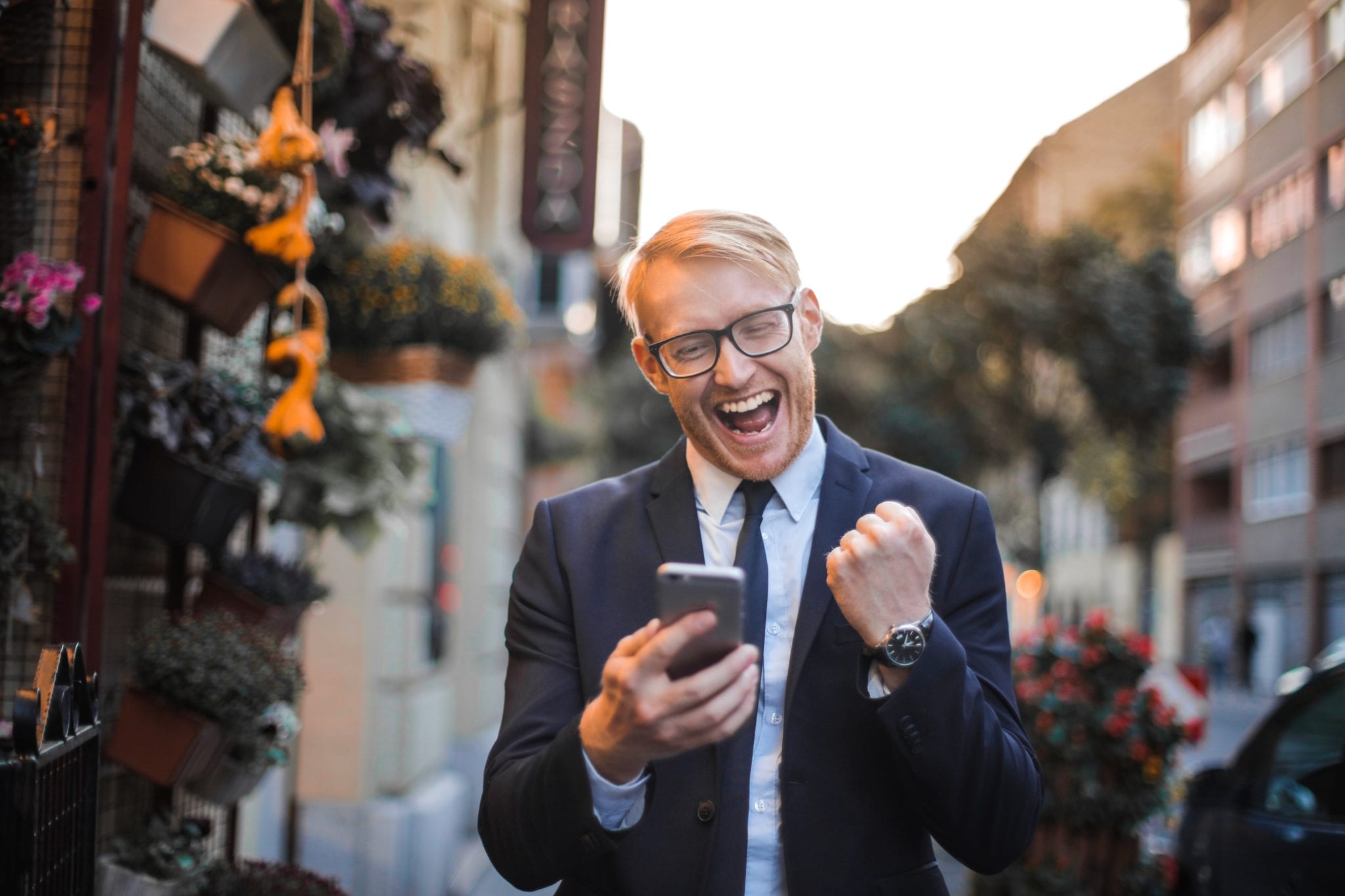 man receives good news from his phone