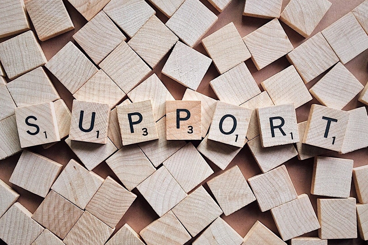 scrabble tiles spell the word support