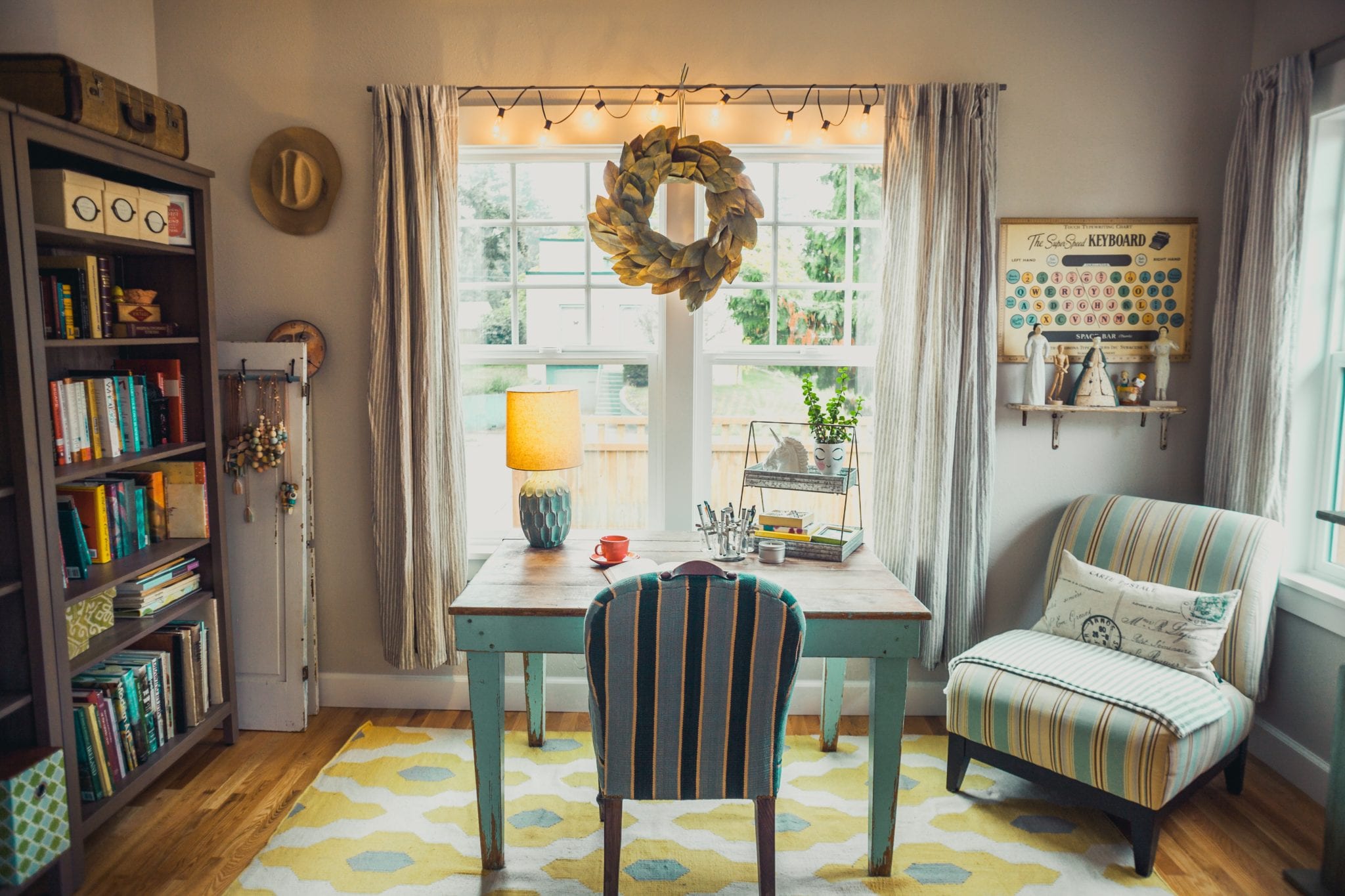 beige table lamp on table with chair in room by window