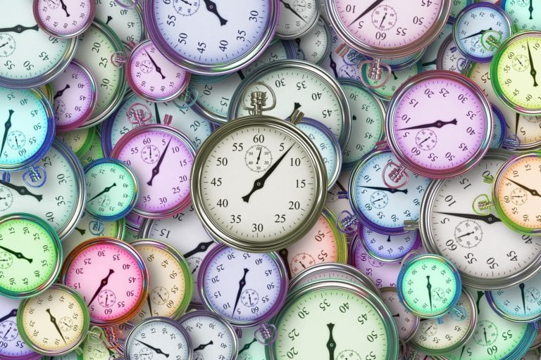 multicolor clock faces in a pile