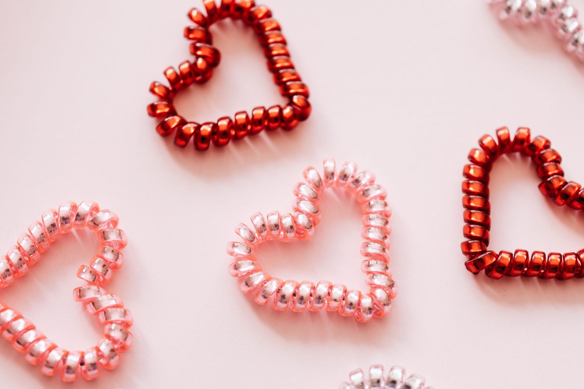 multicolored hearts on a pink background