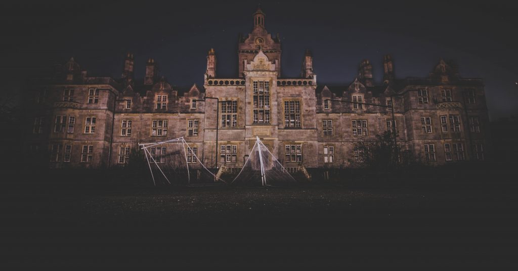 stone castle at night with light shining on it